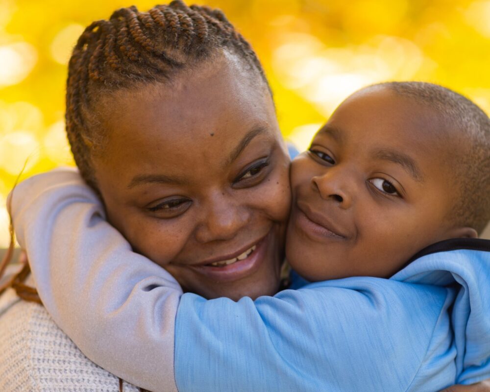 Tahitia and her son, Brendan, hug