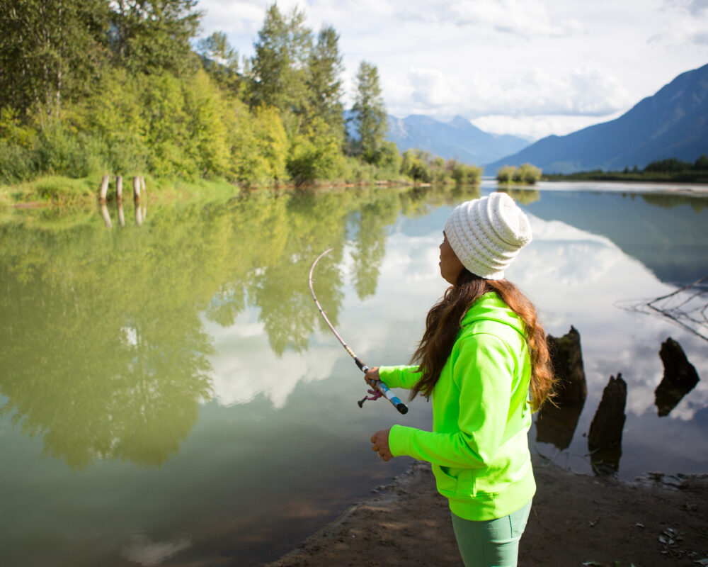 Woman fishing in lake